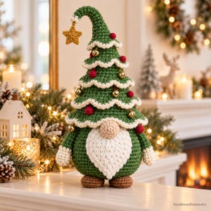 May include: A crochet gnome figurine featuring a tall, green, tree-shaped hat with white scalloped trim, small red pom-poms, and gold jingle bells. The gnome has a round beige nose, a white beard, and brown feet. Text reads YarnBloomPatternsCo.