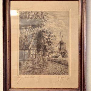May include: A framed etching depicting a rural landscape with a thatched-roof cottage, trees, and a windmill in the distance. The artwork features the handwritten text Original Etching and a signature at the bottom, enclosed in a dark wood frame.