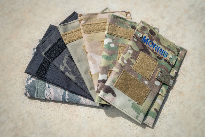 May include: A set of six camouflage fabric pouches with velcro closures. One pouch has the name "MORRIS" embroidered on it in blue thread.
