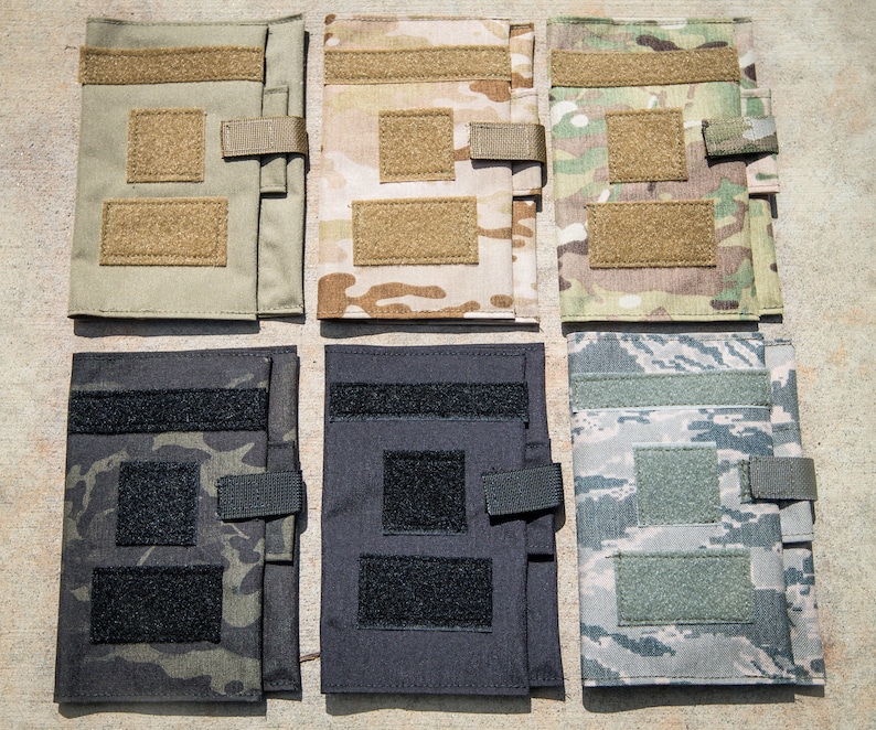 May include: Six different camouflage patterned notebook covers with velcro closures. The covers are made of a durable fabric and have a variety of colors and patterns.