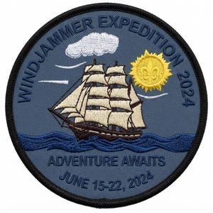 May include: A circular embroidered patch with a blue background featuring a sailing ship, a white cloud, and a yellow sun with a fleur-de-lis. Text reads WINDJAMMER EXPEDITION 2024, ADVENTURE AWAITS, and JUNE 15-22, 2024. The patch has a black stitched border.