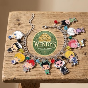 May include: A silver-toned metal charm bracelet featuring multiple colorful enamel character charms and small translucent beads. The charms depict various anime-style figures with distinct hair colors and outfits. A circular logo reads WENDY'S COSPLAY WARES.
