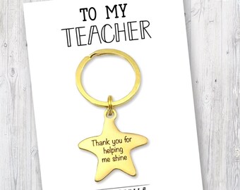 May include: Gold keychain with a star charm that says "Thank you for helping me shine". The keychain comes with a card that says "To My Teacher".