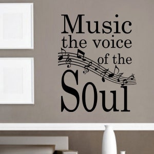 May include: Black and white wall decal with musical notes and the text "Music the voice of the Soul".