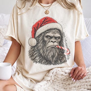 Bigfoot Santa Comfort Colors Tee, Grumpy Sasquatch in Santa Hat with Candy Cane, Vintage Sketch Cryptid, Funny Christmas Gift for Him