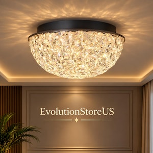 May include: A dome-shaped flush mount ceiling light fixture featuring a black circular base and a faceted clear crystal shade that emits a warm, glowing light with starburst patterns. The text EvolutionStoreUS is printed below the light.