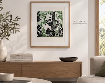 May include: A framed square print featuring a black and white panda climbing a tree amidst green foliage. The artwork is labeled with the dimensions 30.5 x 22.6 cm. The print is displayed in a light wood frame with a white mat border.