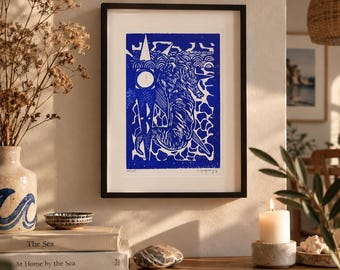 May include: A framed linocut print featuring a stylized seahorse in deep blue ink on a white background. The artwork includes geometric shapes, wave patterns, and a circular sun motif. The print is signed and numbered in the bottom corner.