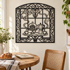 May include: A black metal wall art piece featuring a decorative arched frame with a window-like grid. The design depicts a table with a moka pot, two cups with rising steam, and a tiered stand holding pastries, all rendered in a flat, cutout style.