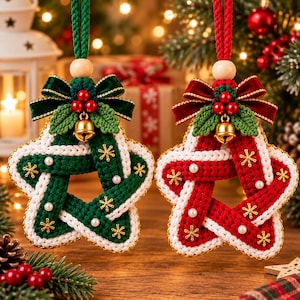 May include: Two star-shaped ornaments made of braided yarn, one in dark green and one in red, both trimmed with white edges. Each features a velvet bow, three red berries, a small gold bell, white pearls, and gold snowflake accents.