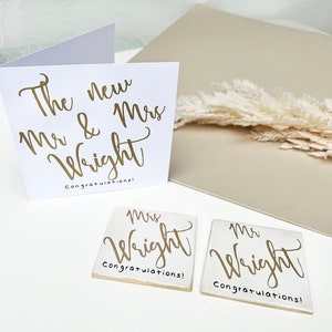 White square card with gold text: The new Mr & Mrs NAME congratulations!
Matching white square coasters with gold text: Mrs NAME congratulations.
Matching white square coasters with gold text: Mr NAME congratulations.