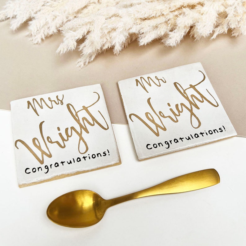 White square coasters with gold text: Mrs NAME congratulations.
Matching white square coasters with gold text: Mr NAME congratulations.