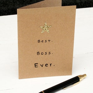Kraft card with gold glitter star at the top and black text: best boss ever