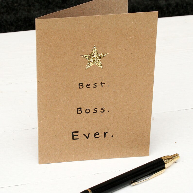 Kraft card with gold glitter star at the top and black text: best boss ever