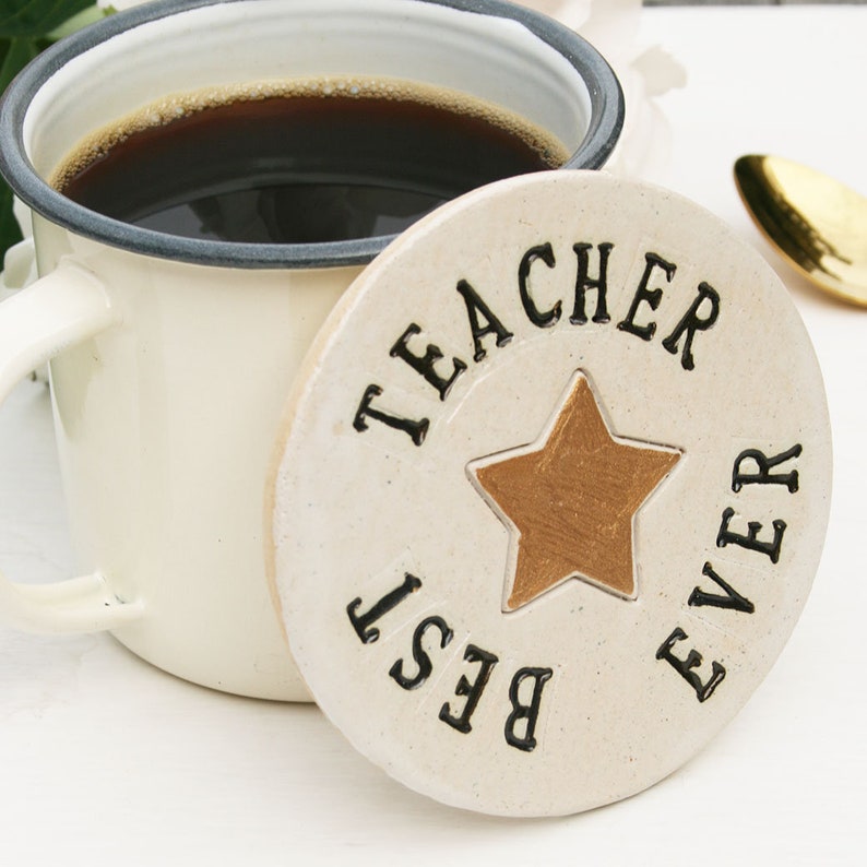 White round coaster with gold star in the centre and black text around the edge: BEST TEACHER EVER
Craft rectangular card the has a gold star at the top and black text: Best Teacher Ever