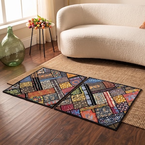 May include: Two rectangular floor mats featuring a vibrant patchwork design composed of various fabric segments in shades of blue, red, yellow, and green. The mats display intricate patterns, small circular mirror accents, and black borders.