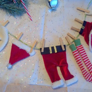 Clothesline made out of pvc plastic water pipes and thick yarn. Hung baby  girl clothes & socks with small clothes pins…