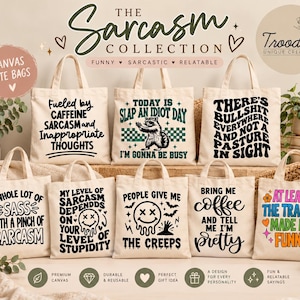May include: A collection of nine off-white canvas tote bags, each featuring unique black or colourful graphic text and illustrations. The designs include phrases like Fueled by Caffeine, Slap an Idiot Day, and At Least the Trauma Made Me Funny.