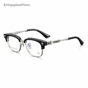 May include: Black and silver-tone eyeglasses with a semi-rimless frame design. The temples feature intricate metallic detailing and fleur-de-lis accents. The lenses are clear, and the text KirieyeglassFrame appears in the upper left corner.