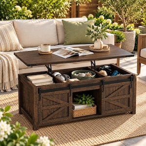 May include: A dark brown wooden coffee table with a lift-top mechanism revealing interior storage compartments. The base features two sliding barn-style doors with black metal hardware and a central open shelf containing a woven basket and a plant.