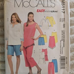 May include: A McCall's M5117 sewing pattern envelope for sizes 18W-24W. The front displays illustrations of tops, shorts, and pants in white, yellow, pink, and blue. Text includes "McCall's," "EASY," "ENDLESS options," and "SELECT-A-SIZE" with a barcode.