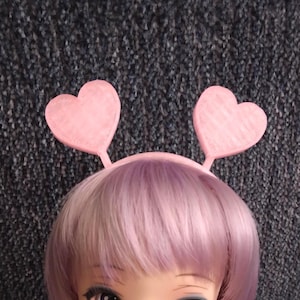 May include: A set of three ceramic mugs with a speckled, matte finish. Each mug features a different color: light blue, cream, and gray. The mugs have a simple, modern design with a rounded shape and a comfortable handle.