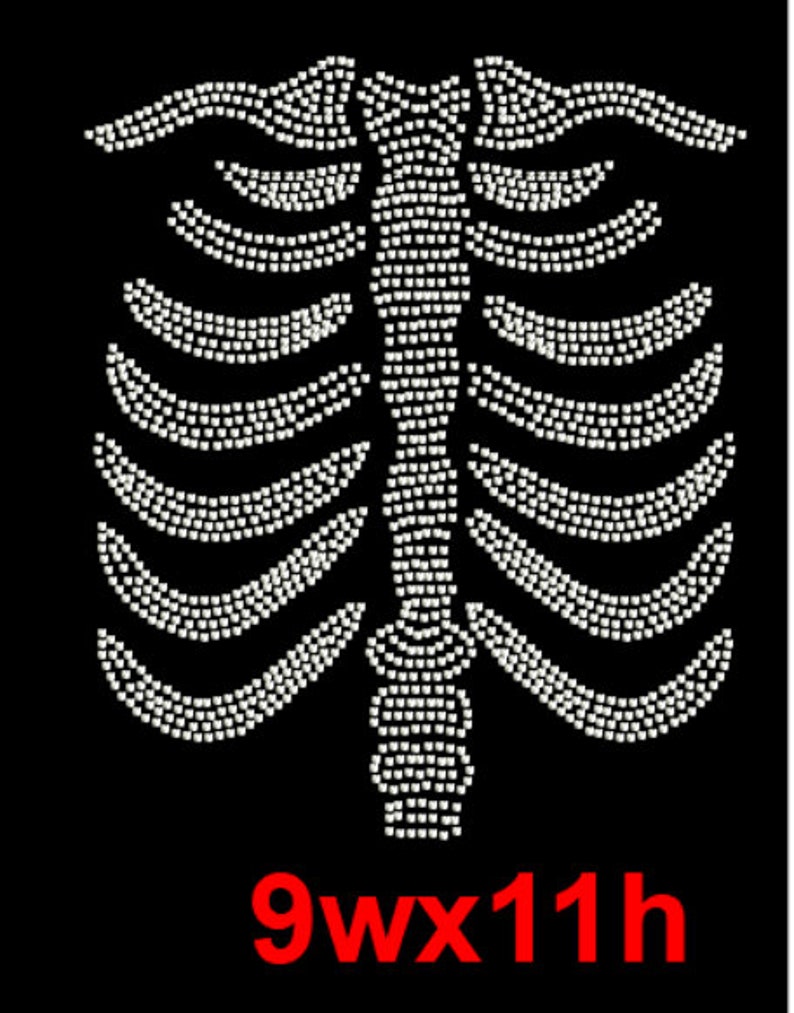 May include: White rhinestone design of a ribcage on a black background. The design measures 9 inches wide by 11 inches high.