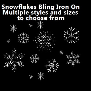 May include: A collection of iron-on snowflake designs in various sizes and styles. The snowflakes are made of white rhinestones and are perfect for adding a festive touch to clothing, bags, or other crafts.