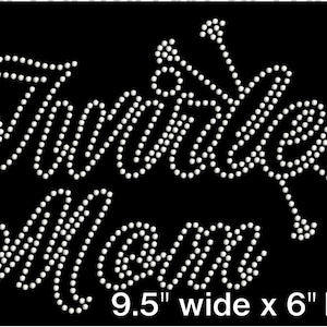 May include: White rhinestone design on a black background that reads "Twinkle Mom" with a 9.5 inch width and 6 inch height.
