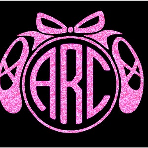 May include: Pink glitter monogram with the letters "ARC" inside a circle, surrounded by two pink glitter ballet shoes with a pink glitter bow on top.