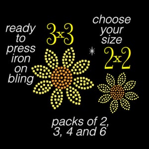 May include: Two sunflower-shaped iron-on rhinestone transfers on a black background. Text reads: ready to press iron on bling, 3x3, choose your size, 2x2, packs of 2, 3, 4 and 6. The flowers feature yellow petals and orange centers made of small studs.