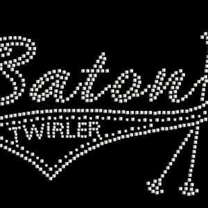 May include: A white rhinestone design of the word "Batman" with a baseball-style graphic and the word "Twirler" underneath.