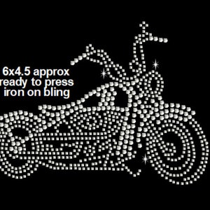 May include: A silver rhinestone iron-on design of a motorcycle, approximately 6 inches by 4.5 inches.  The design is ready to press onto fabric.