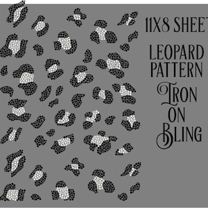 May include: A gray sheet featuring a leopard pattern design made of black and white rhinestones. The text on the sheet reads "11X8 SHEET LEOPARD PATTERN IRON ON BLING."