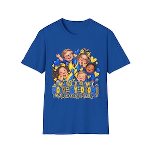 May include: A royal blue short-sleeve t-shirt featuring a graphic of four children and a yellow and blue awareness ribbon. The text reads I Support DOWN SYNDROME Awareness Month. The design includes yellow hearts and blue accents throughout the print.