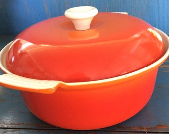 Cast iron pot. Vintage orange cast iron casserole . Vintage Belgium casserole pot .