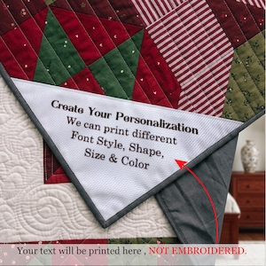 May include: A quilted blanket featuring a patchwork pattern of red, green, and white fabric with a folded corner revealing a white textured area with the text: Create Your Personalization. We can print different Font Style, Shape, Size & Color.