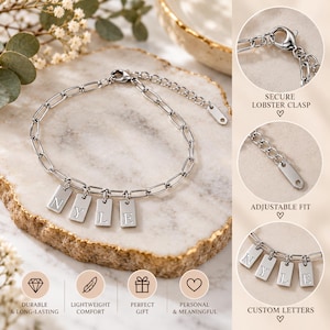 Peut inclure: Un bracelet à chaîne argentée doté de quatre breloques rectangulaires gravées des lettres N, Y, L et E. Le bracelet comprend un fermoir mousqueton sécurisé et une extension de chaîne réglable pour un ajustement personnalisé.