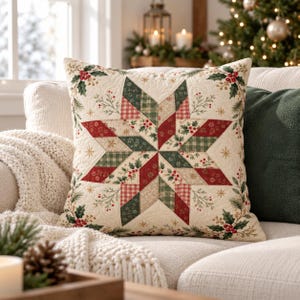 May include: A square throw pillow featuring a central eight-pointed star quilt pattern in shades of red, dark green, and cream. The fabric displays a festive print of holly leaves, red berries, and gold snowflakes on a cream background.