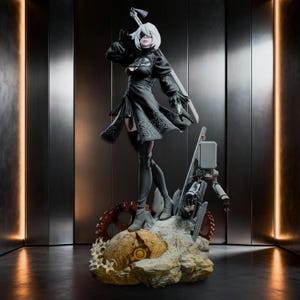 May include: A detailed collectible figurine of a character with short white hair, wearing a black dress with intricate embroidery, a blindfold, and thigh-high boots. A long sword is strapped to the back, and a small robotic companion stands nearby.