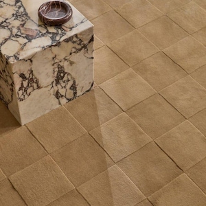 Toffee brown hand tufted rug featuring a modern high low pile design and raised geometric checkerboard pattern, perfect for contemporary home decor.