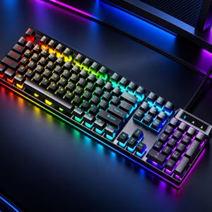May include: A black mechanical keyboard featuring a full QWERTY layout with a numeric keypad. The keys are backlit with vibrant RGB lighting that transitions from red and orange on the left to blue and purple on the right side.