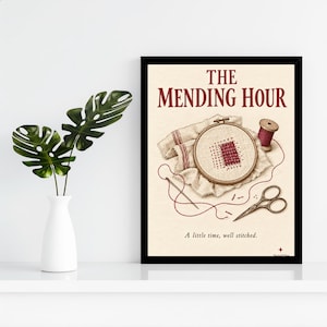 May include: A framed print titled THE MENDING HOUR featuring an illustration of a wooden embroidery hoop with fabric, a needle, red thread, a spool, and scissors. The text reads THE MENDING HOUR and A little time, well stitched.