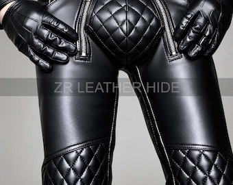 May include: Black leather trousers featuring a quilted codpiece, two vertical silver-tone zips on the front, and quilted knee panels. The trousers include a belt at the waist and are paired with matching black leather gloves. Text reads ZR LEATHER HIDE.