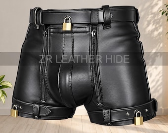 May include: Black leather shorts featuring a waist belt with a gold padlock, two vertical zippered pockets on the front, and adjustable leg straps secured with gold padlocks. The text ZR LEATHER HIDE is printed across the centre of the garment.