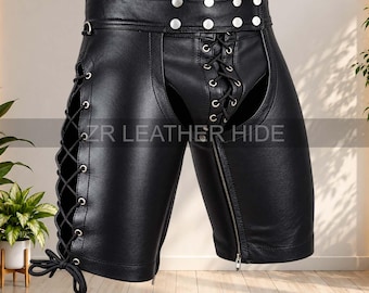 May include: Black leather shorts featuring a high waistband with silver-tone metal studs, side lace-up detailing with black cords, and a front lace-up closure. The garment includes a vertical zipper on the left leg and the text ZR LEATHER HIDE.
