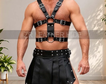 May include: A black leather chest harness featuring silver-toned metal buckles, rivets, and circular rings, paired with a matching black leather kilt-style skirt adorned with silver rivets along the waistband and the bottom hem edges.