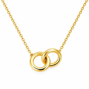 May include: A gold-coloured necklace featuring a delicate chain and a pendant composed of two interlocking circular rings. The metal has a polished, reflective finish, and the design is symmetrical, with the two rings joined together at the centre.
