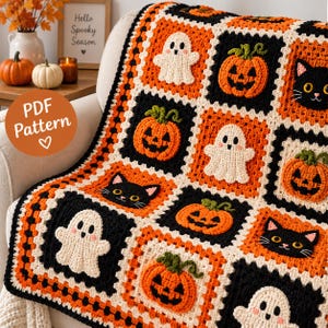 May include: A crochet blanket featuring a repeating granny square pattern with motifs of white ghosts, orange jack-o'-lanterns, and black cat faces. The squares are bordered in cream, orange, and black yarn, creating a festive Halloween design.