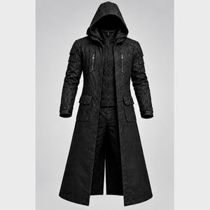 May include: A long black hooded coat featuring a structured design with a high collar, full-length front zipper, and multiple utility pockets on the chest and hips. The garment includes shoulder detailing and long sleeves with adjustable cuffs.